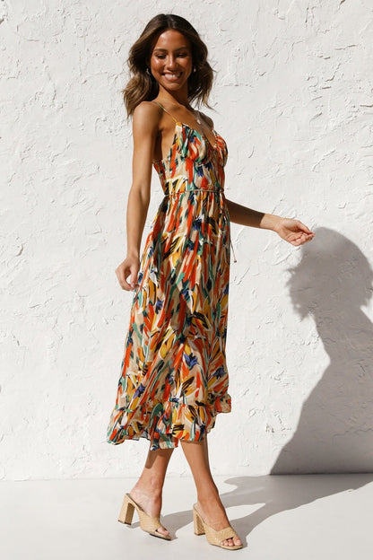 Woman in flowing multi-colored chiffon midi dress