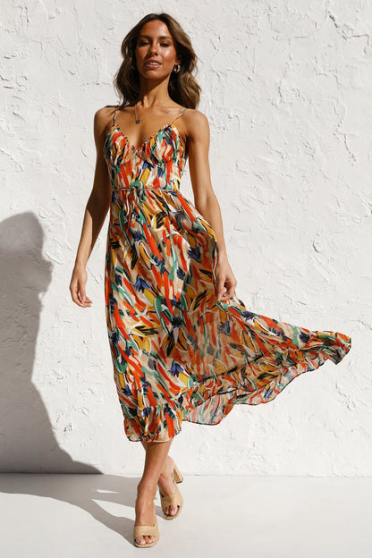 Woman in flowing multi-colored chiffon midi dress