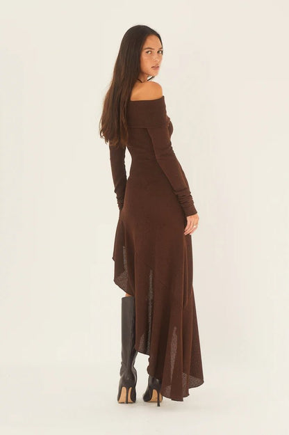 Woman in brown off-the-shoulder ribbed knit dress and black heeled boots
