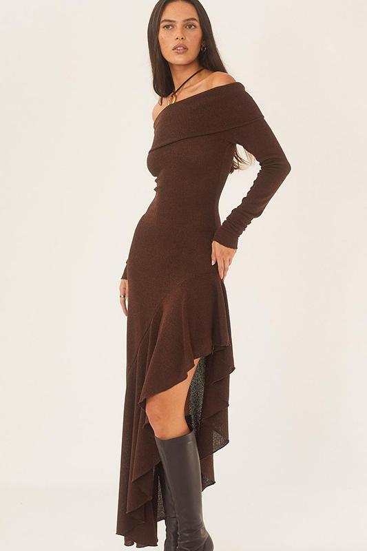 Woman in brown off-the-shoulder ribbed knit dress and black heeled boots