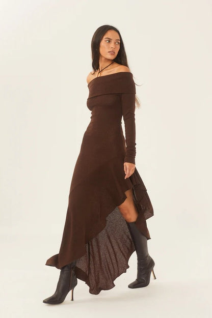 Woman in brown off-the-shoulder ribbed knit dress and black heeled boots