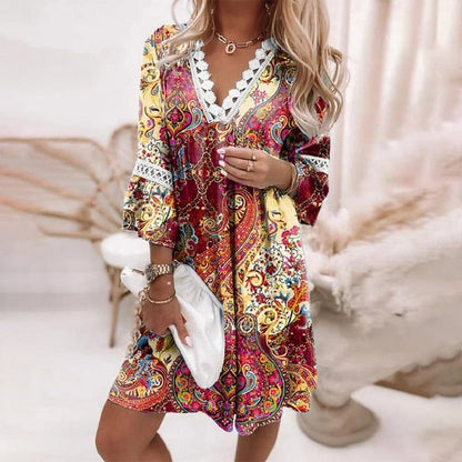 Red - A woman wearing a white mini sundress with a blue Mediterranean botanical print, featuring a V-neckline with white crochet lace trim and 3/4 bell sleeves with lace inserts.
