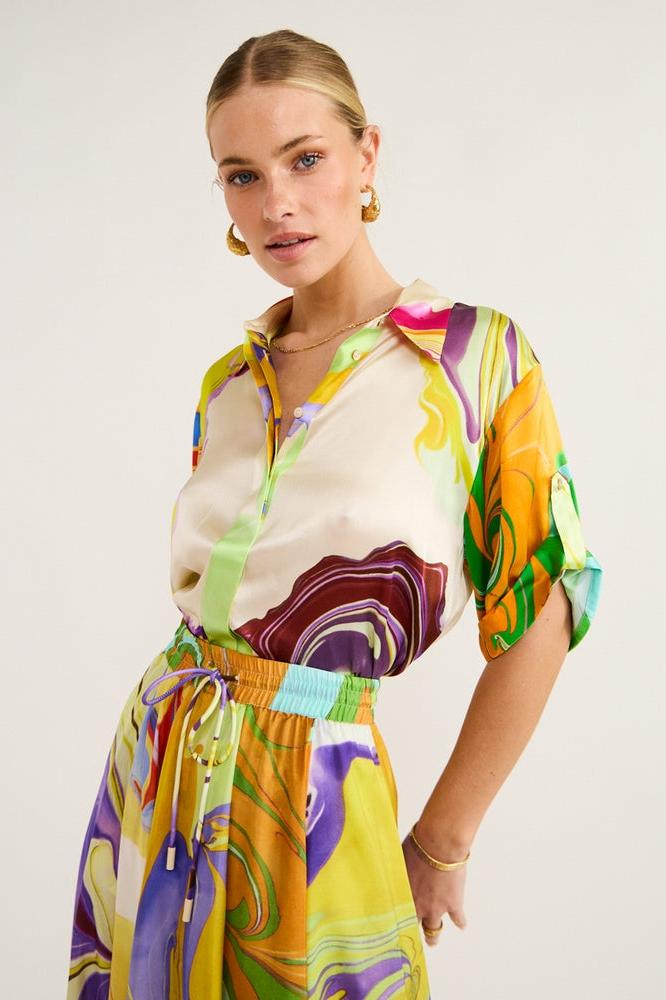 Woman wearing multicolor marble print satin skirt set
