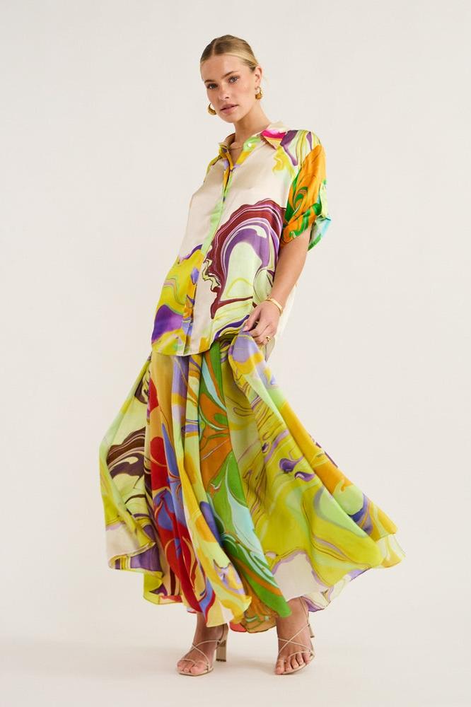 Woman wearing multicolor marble print satin skirt set