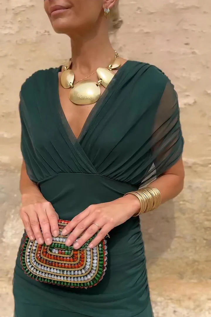Woman in floral chiffon off-the-shoulder maxi dress