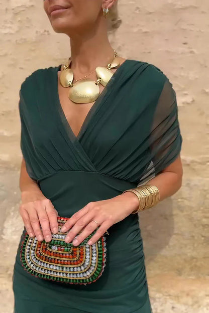Woman in floral chiffon off-the-shoulder maxi dress