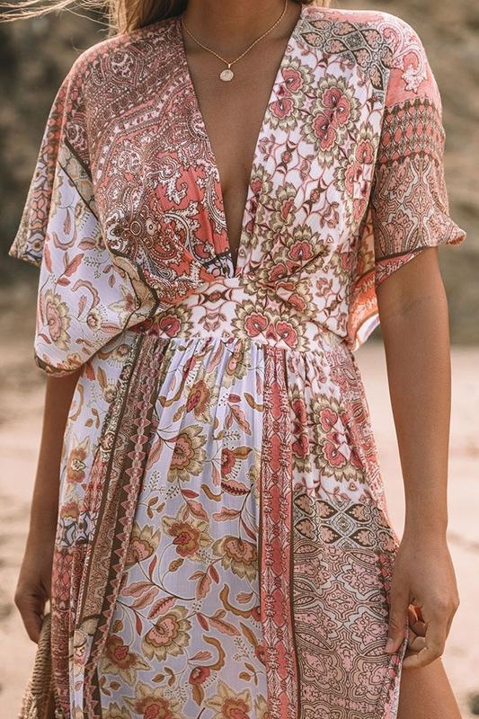 Woman in peach floral maxi dress on beach