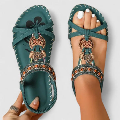 Amazon Green - Faux-leather flat slingback sandals featuring a beaded medallion centerpiece, embroidered instep strap, and contrast stitching along the sole edge.