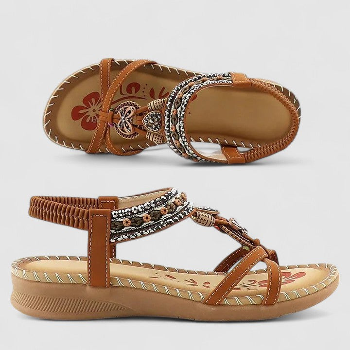Beige Bali - Faux-leather flat slingback sandals featuring a beaded medallion centerpiece, embroidered instep strap, and contrast stitching along the sole edge.