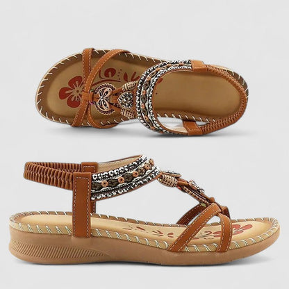 Beige Bali - Faux-leather flat slingback sandals featuring a beaded medallion centerpiece, embroidered instep strap, and contrast stitching along the sole edge.