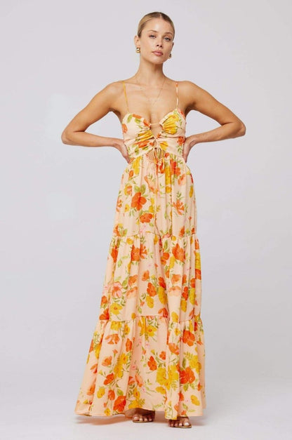Woman in pink and purple floral print maxi dress