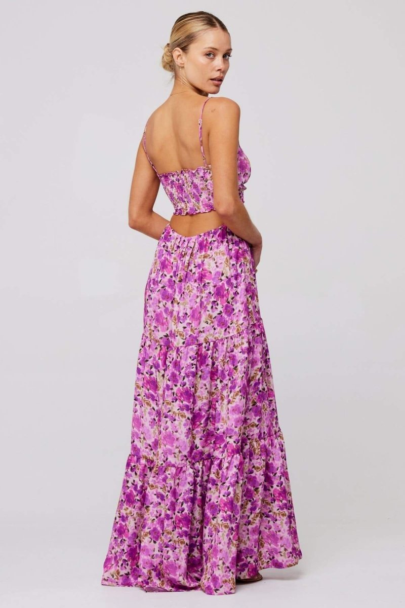 Woman in pink and purple floral print maxi dress