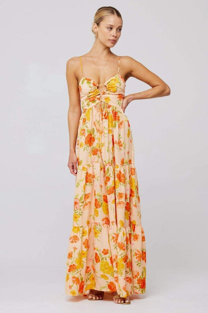 Woman in pink and purple floral print maxi dress