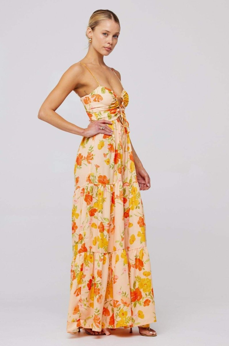 Woman in pink and purple floral print maxi dress