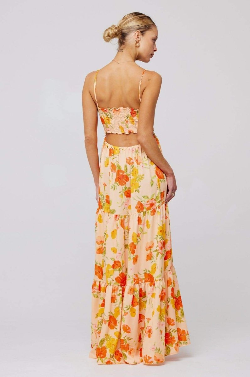 Woman in pink and purple floral print maxi dress