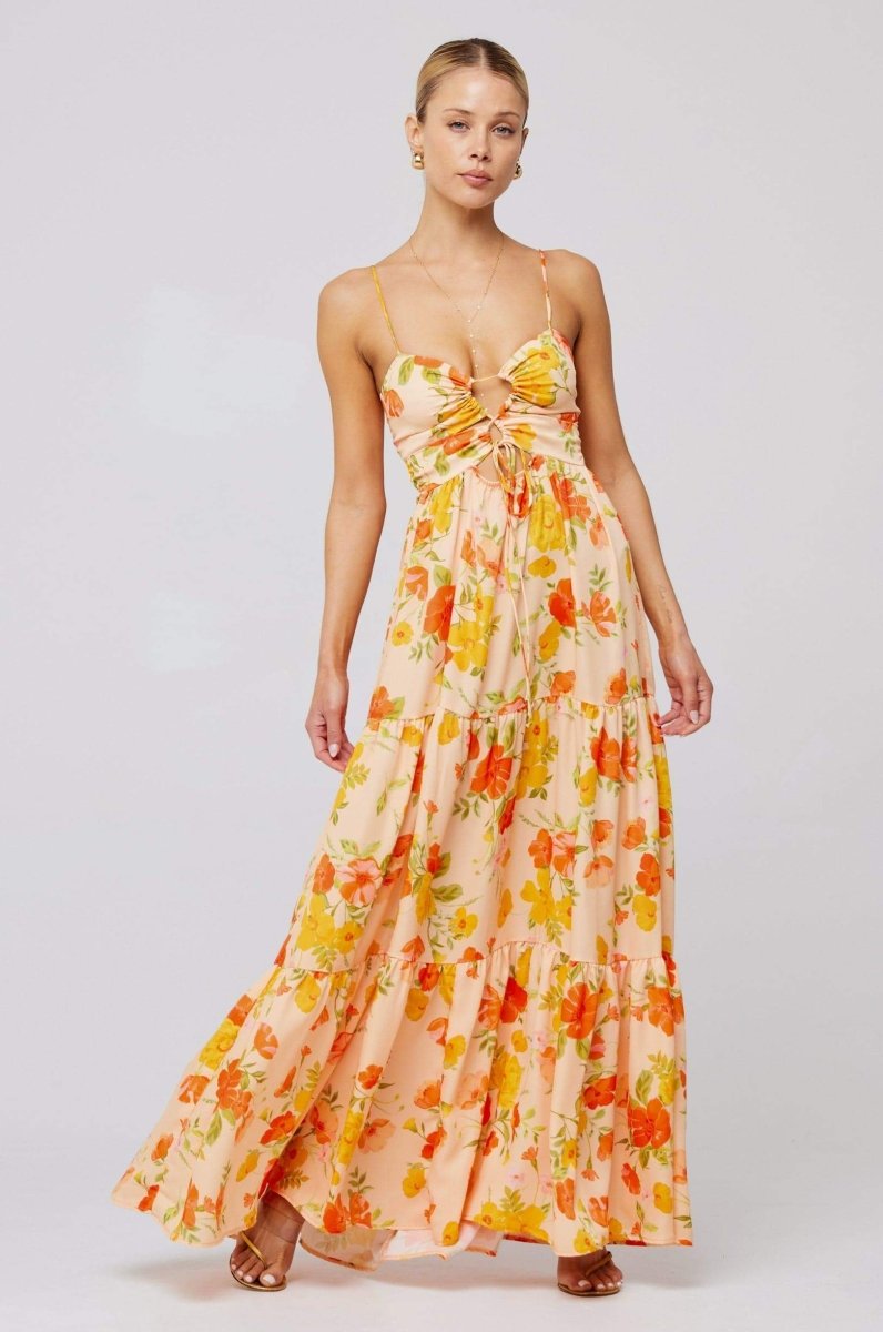 Woman in pink and purple floral print maxi dress