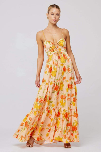 Woman in pink and purple floral print maxi dress