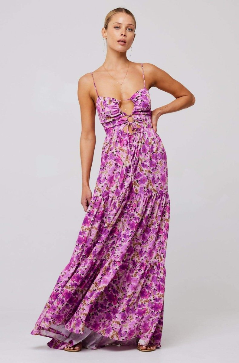 Woman in pink and purple floral print maxi dress