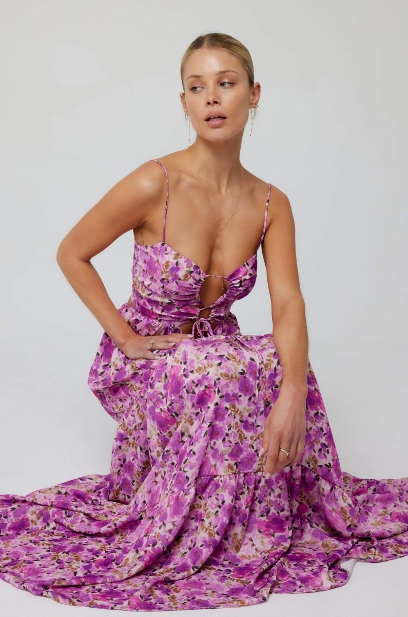 Woman in pink and purple floral print maxi dress