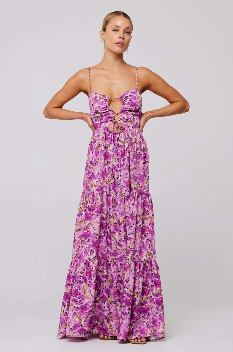 Woman in pink and purple floral print maxi dress