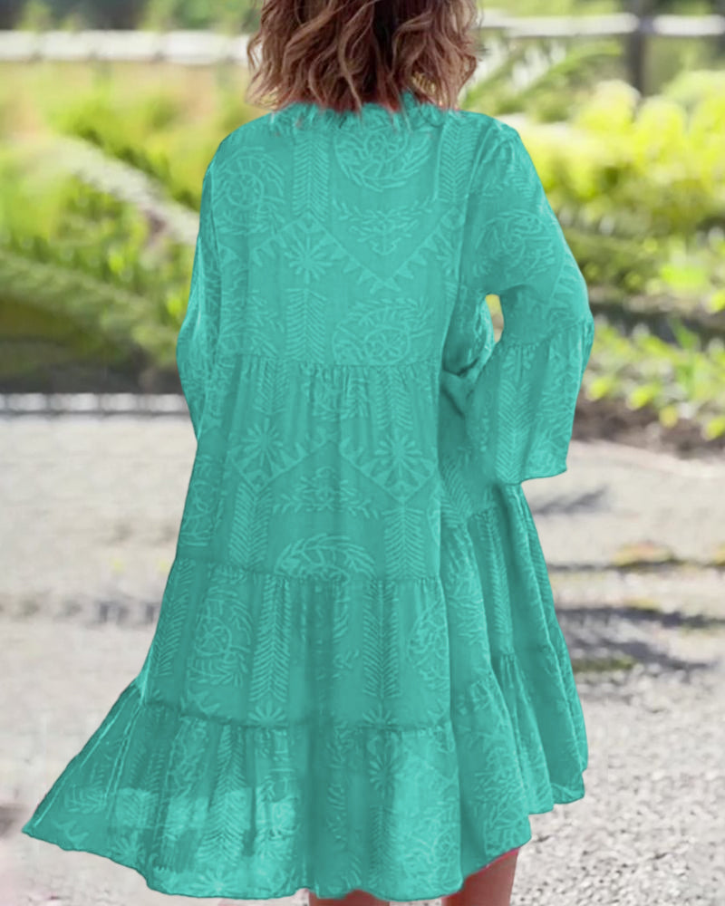 Red - A woman wearing a vibrant red and pink tropical botanical print midi sundress with three-quarter bell sleeves, a split V-neckline, and a tiered flowy skirt.
