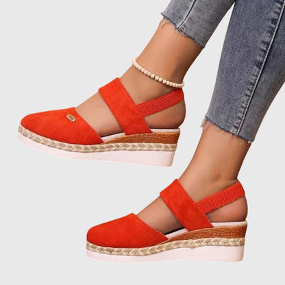 Orange - Women's canvas closed-toe platform sandals featuring an elastic slingback strap, layered cork and braided-jute midsole, and a white rubber traction outsole.