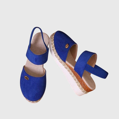 Blue - Women's canvas closed-toe platform sandals featuring an elastic slingback strap, layered cork and braided-jute midsole, and a white rubber traction outsole.