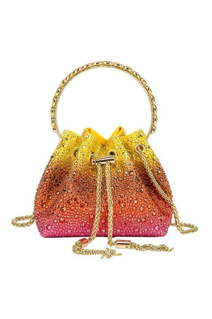 Front view of an ombre bucket bag with gold hardware and drawstring closure
