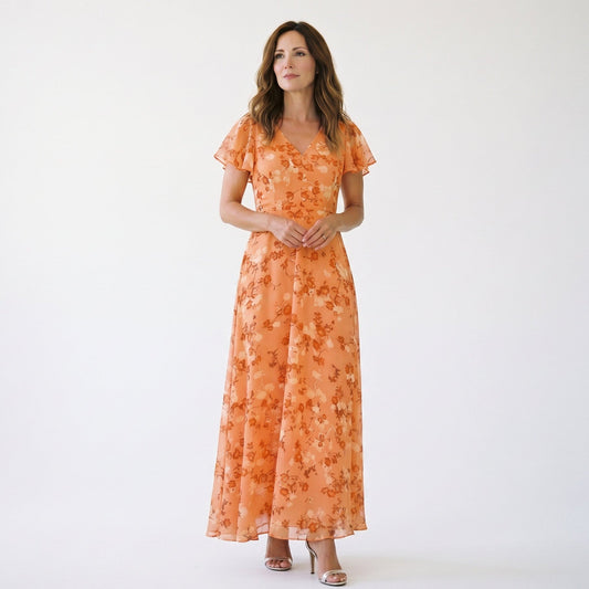 Orange - Model wearing a floral flutter-sleeve maxi dress with a V-neckline and flowy silhouette.