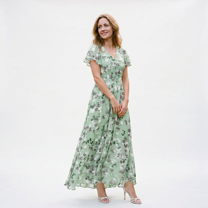 Light Green - Model wearing a floral flutter-sleeve maxi dress with a V-neckline and flowy silhouette.