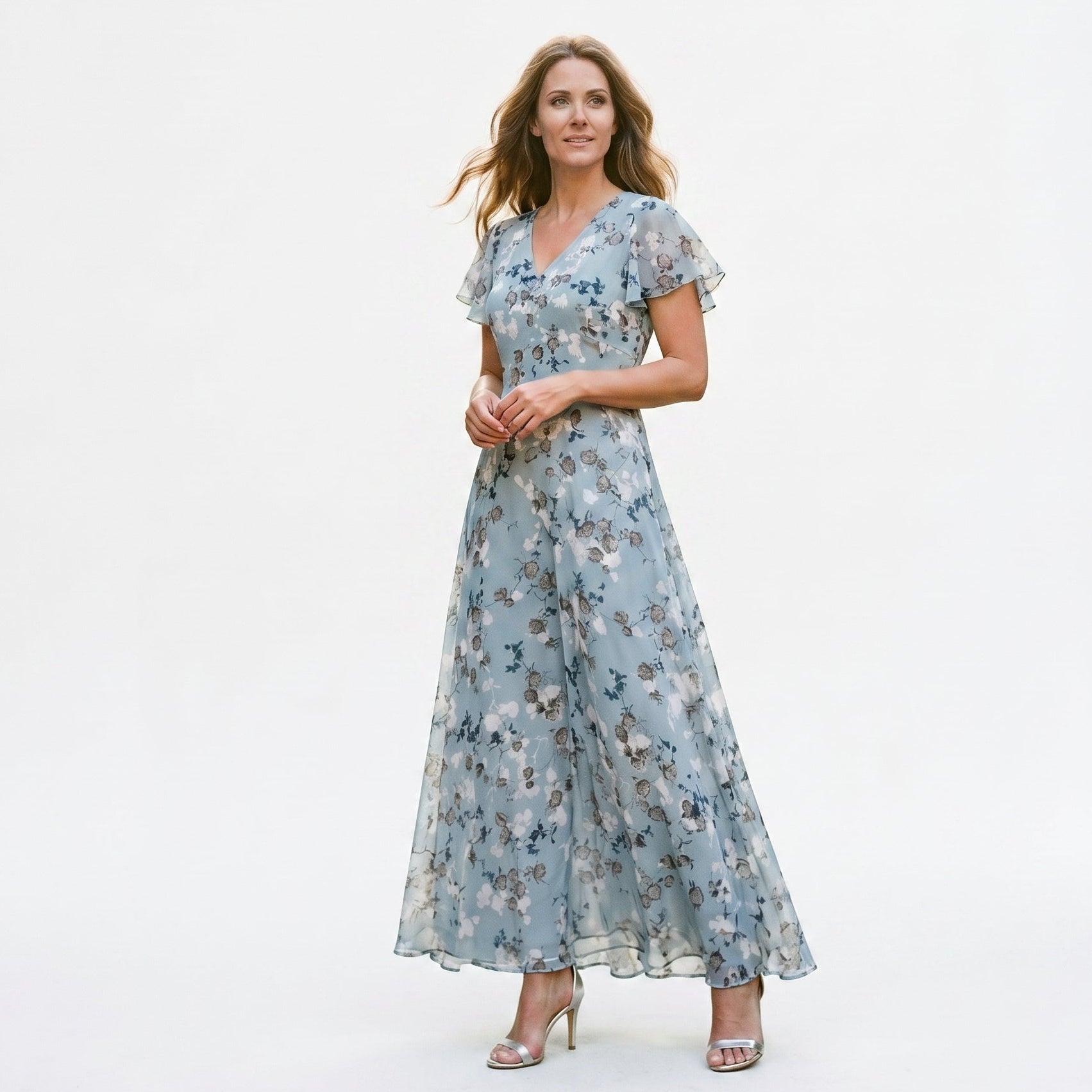 Light Blue - Model wearing a floral flutter-sleeve maxi dress with a V-neckline and flowy silhouette.