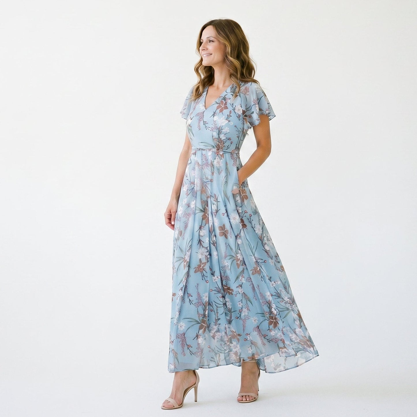 Light Blue 2 - Model wearing a floral flutter-sleeve maxi dress with a V-neckline and flowy silhouette.