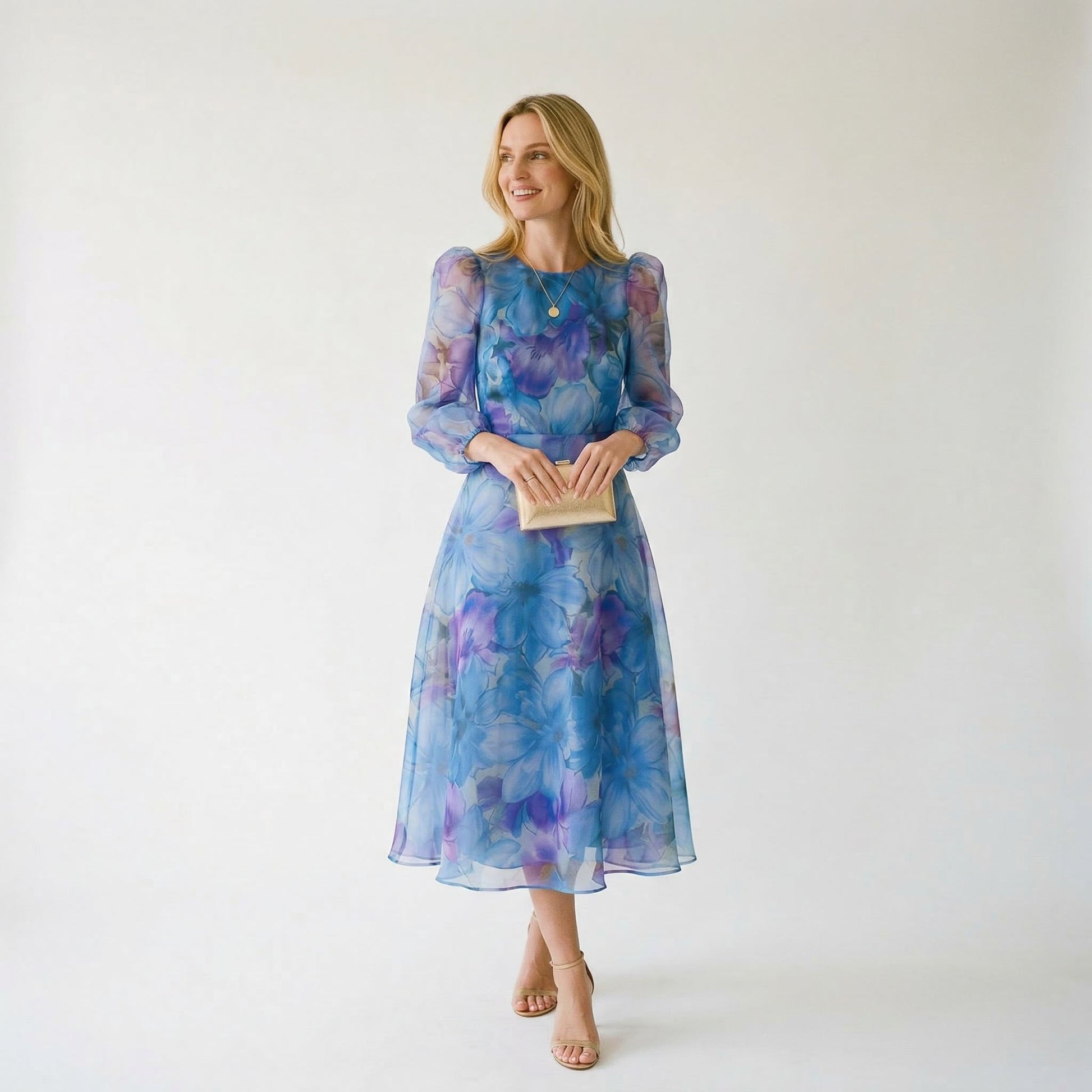 Blue - Model wearing a sheer floral puff-sleeve midi dress featuring a high neckline and flowing A-line skirt.