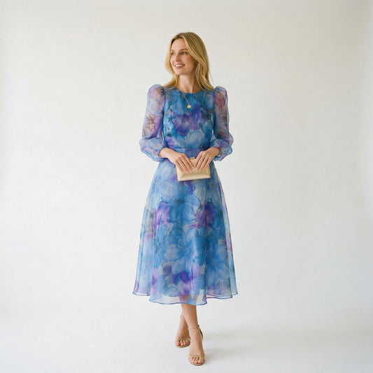 Blue - Model wearing a sheer floral puff-sleeve midi dress featuring a high neckline and flowing A-line skirt.