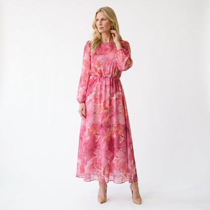 Pink - Model wearing a sheer floral puff-sleeve midi dress featuring a high neckline and flowing A-line skirt.