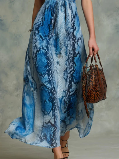 Blue - A woman wearing a flowing blue and white python print chiffon halter maxi dress with a plunging V-neckline, walking forward.