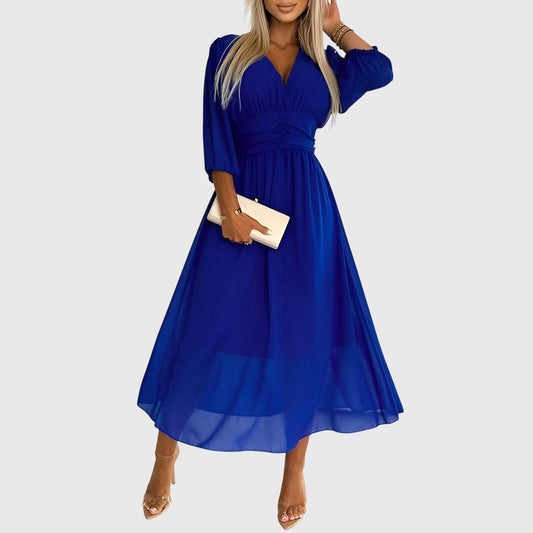 Blue - A woman wearing a royal blue chiffon midi dress featuring a V-neckline, ruched empire waist, 3/4 sleeves, and a flowy A-line skirt with a sheer hem.