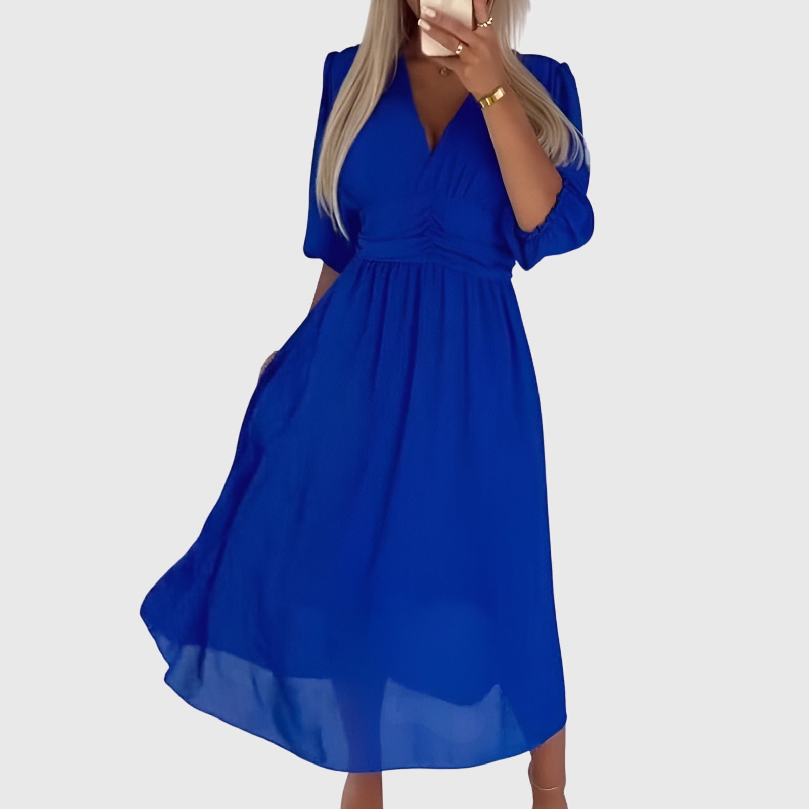 Blue - A woman wearing a royal blue chiffon midi dress featuring a V-neckline, ruched empire waist, 3/4 sleeves, and a flowy A-line skirt with a sheer hem.