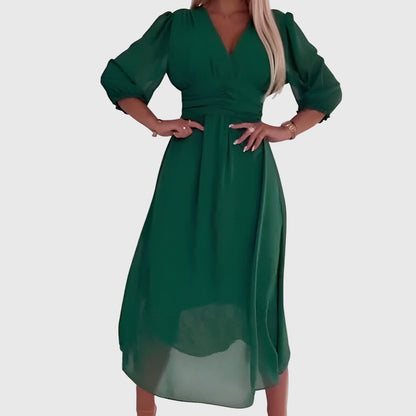 Green - A woman wearing a royal blue chiffon midi dress featuring a V-neckline, ruched empire waist, 3/4 sleeves, and a flowy A-line skirt with a sheer hem.