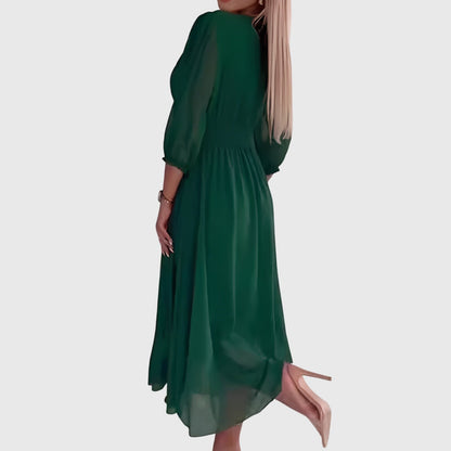 Green - A woman wearing a royal blue chiffon midi dress featuring a V-neckline, ruched empire waist, 3/4 sleeves, and a flowy A-line skirt with a sheer hem.