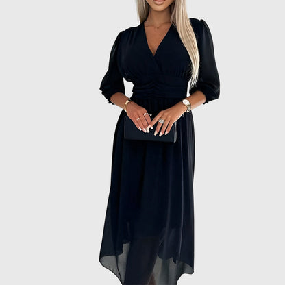 Black - A woman wearing a royal blue chiffon midi dress featuring a V-neckline, ruched empire waist, 3/4 sleeves, and a flowy A-line skirt with a sheer hem.