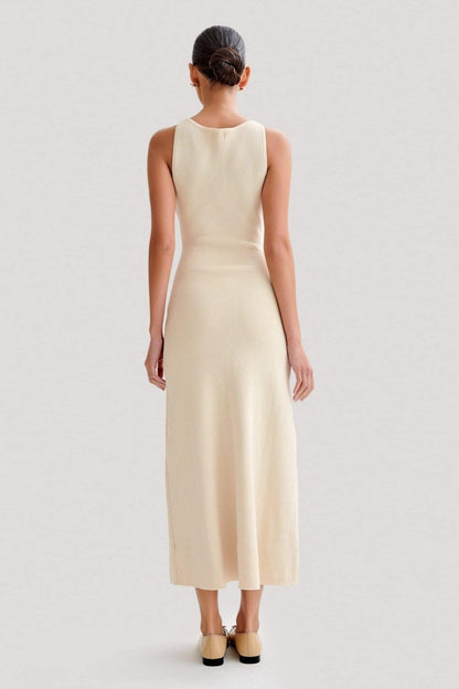 Woman wearing cream ribbed knit maxi dress with buttons