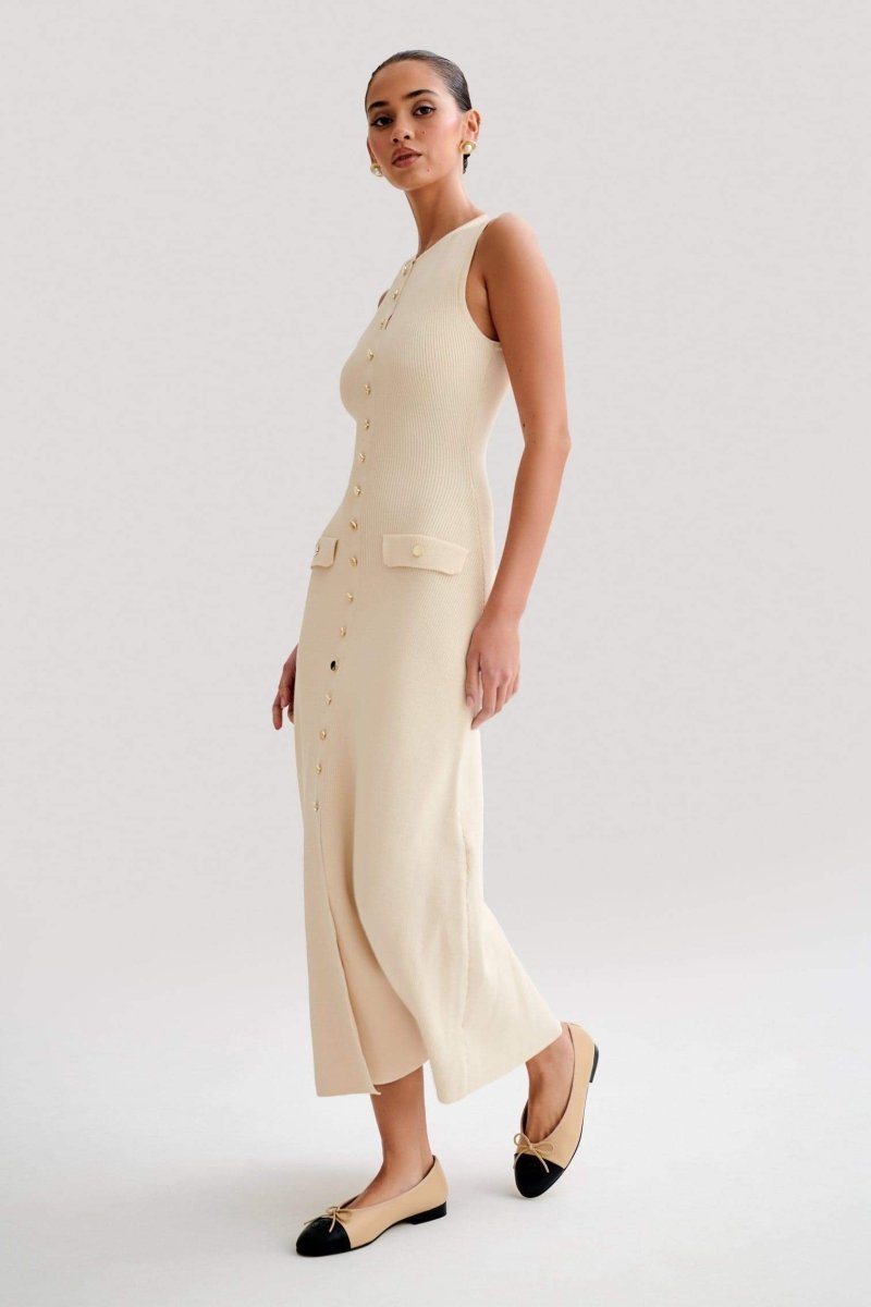 Woman wearing cream ribbed knit maxi dress with buttons