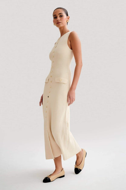 Woman wearing cream ribbed knit maxi dress with buttons