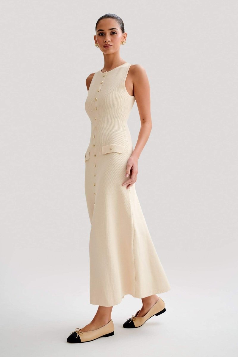 Woman wearing cream ribbed knit maxi dress with buttons