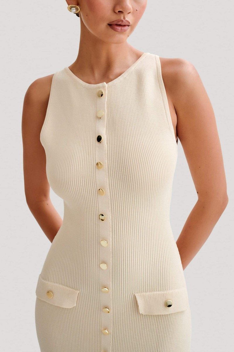 Woman wearing cream ribbed knit maxi dress with buttons