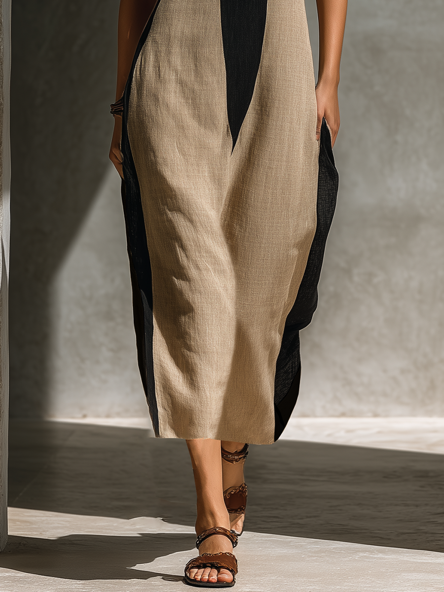 Black And Beige - Model walking in a sleeveless colorblock halter midi dress with a front cutout and relaxed fit.