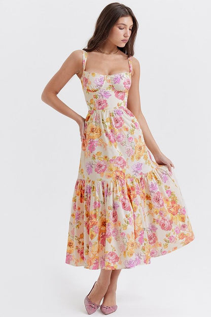 Woman in floral print sundress leaning on stone wall