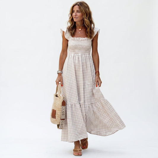 Beige - Woman wearing a gingham smocked maxi dress with flutter sleeves and a tiered skirt on a white background
