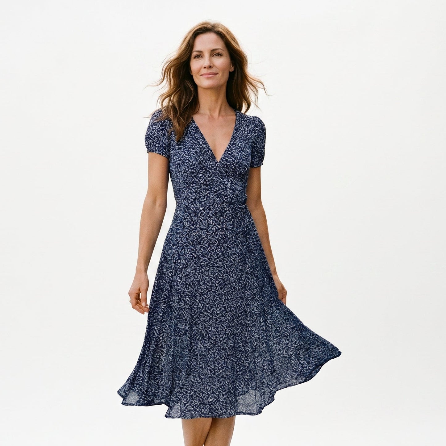 Navy Blue - Woman wearing a floral print midi dress featuring a V-neckline, short puff sleeves, and a flowing skirt.